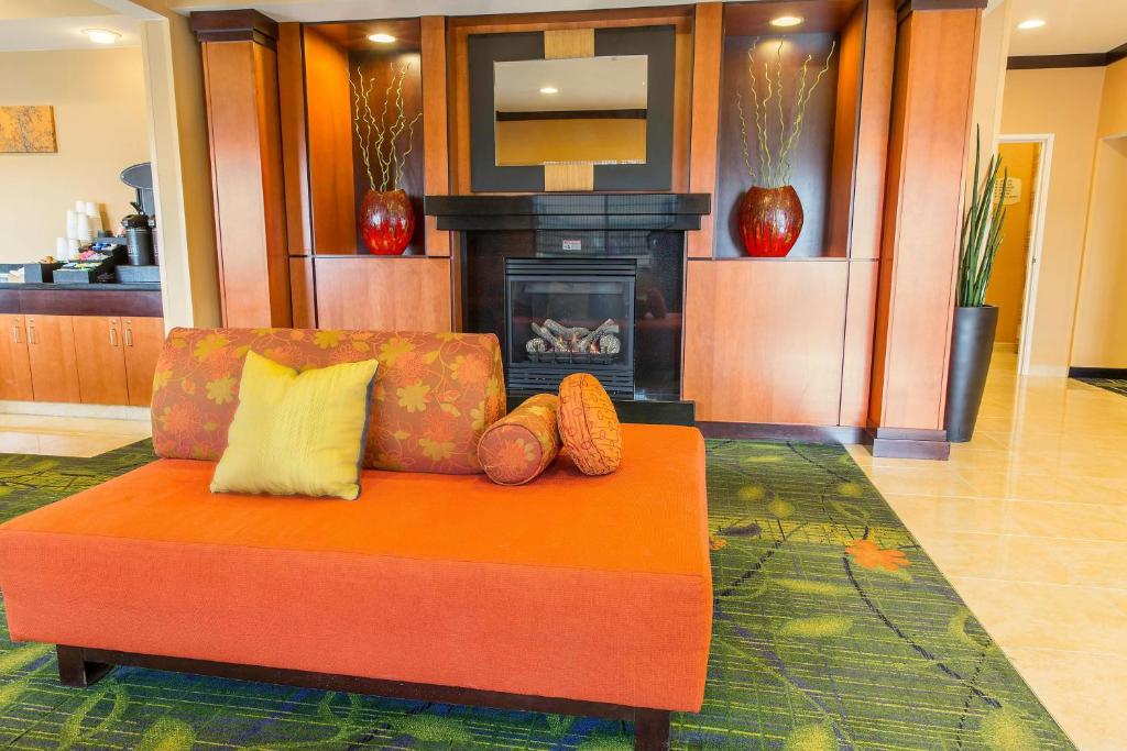 a living room with a couch and a fireplace at Fairfield Inn & Suites Fargo in Fargo