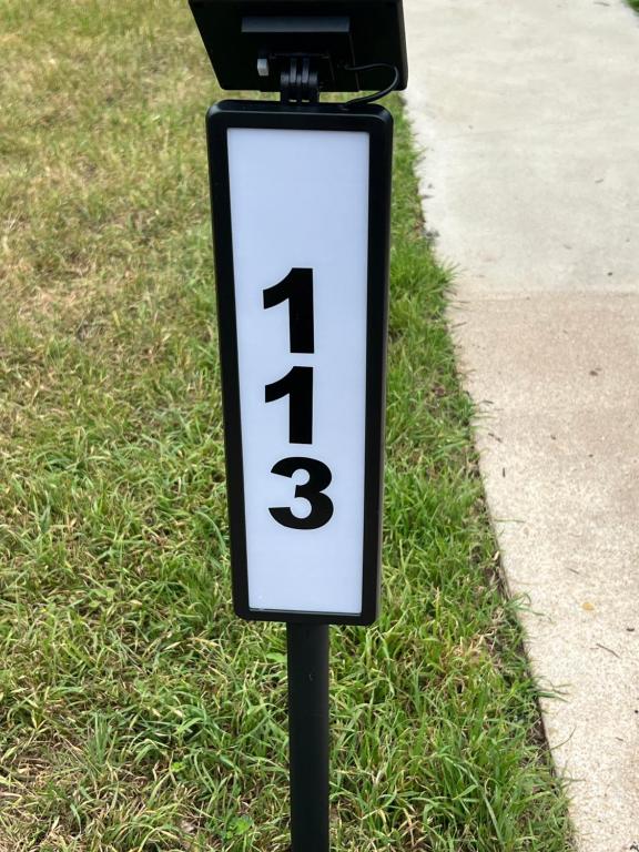 a sign with the number three on it in the grass at The Peacock Cottage in San Marcos