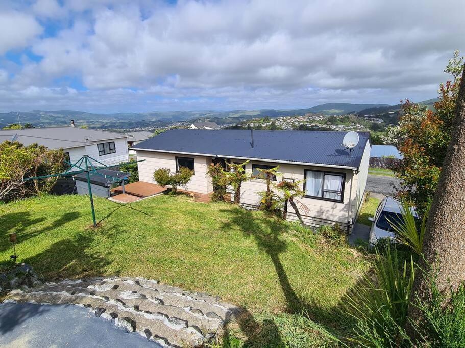 a house on a hill with a yard at Hilltop Blue Sky House in Porirua