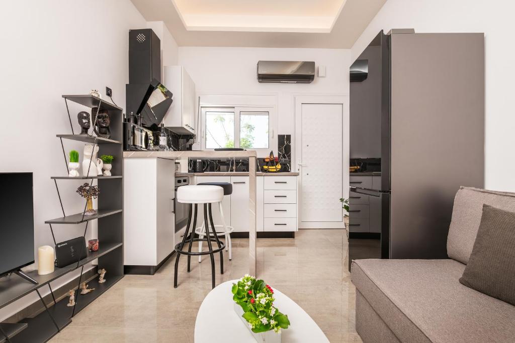 a kitchen and living room with a couch and a table at Magical Brand New Suite in Zipárion