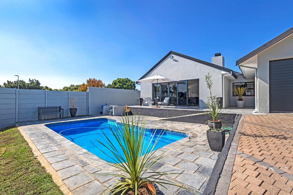 a backyard with a swimming pool and a house at Mountain View Villa in Cape Town