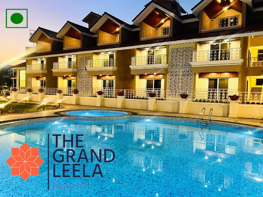 a hotel with a swimming pool in front of a building at The Grand Leela Resort in Khopoli