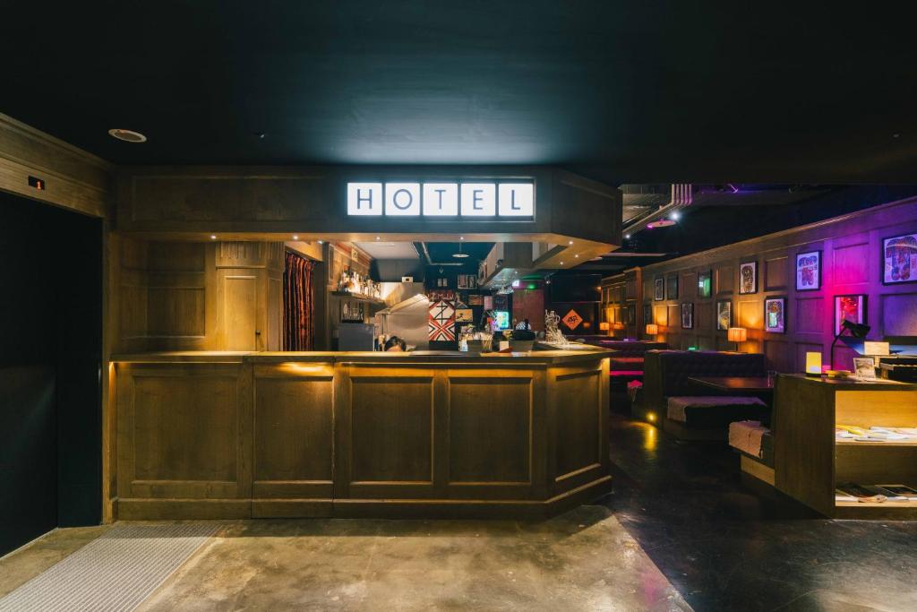 a bar in a restaurant with a sign that reads hotel at SWIIO Hotel Ximending in Taipei