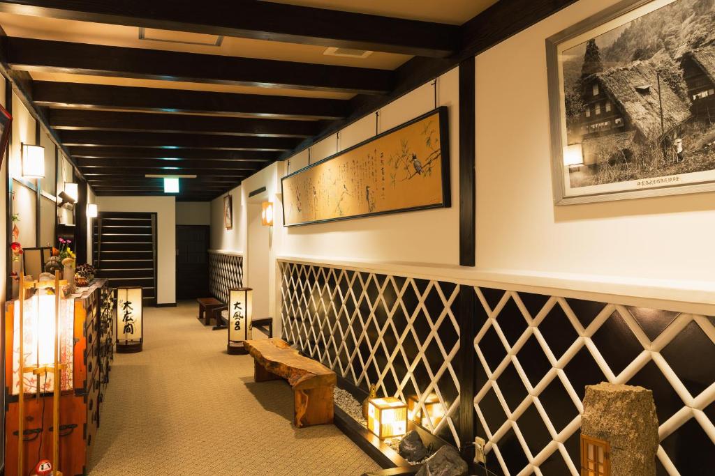 a hallway of a store with a table and benches at Ryokan Asunaro in Takayama