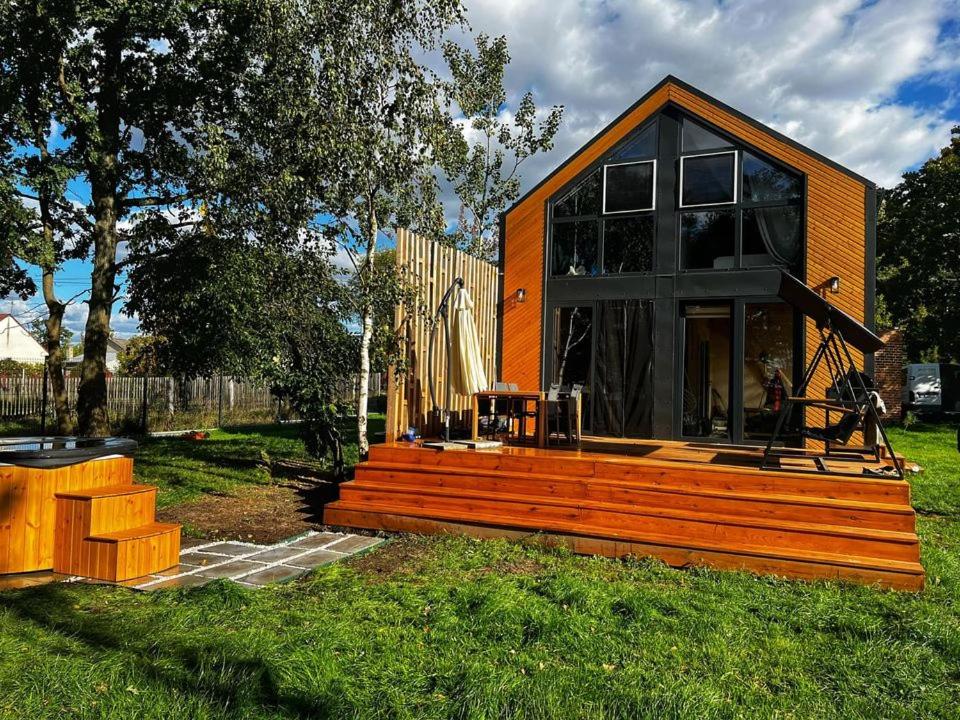 a small house with a large wooden deck at Na.Zadkach 