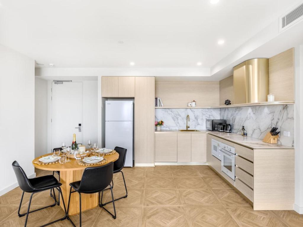a kitchen with a table and chairs in a kitchen at Sweeping Ocean view Apt w Carpark and rooftop pool in Gold Coast