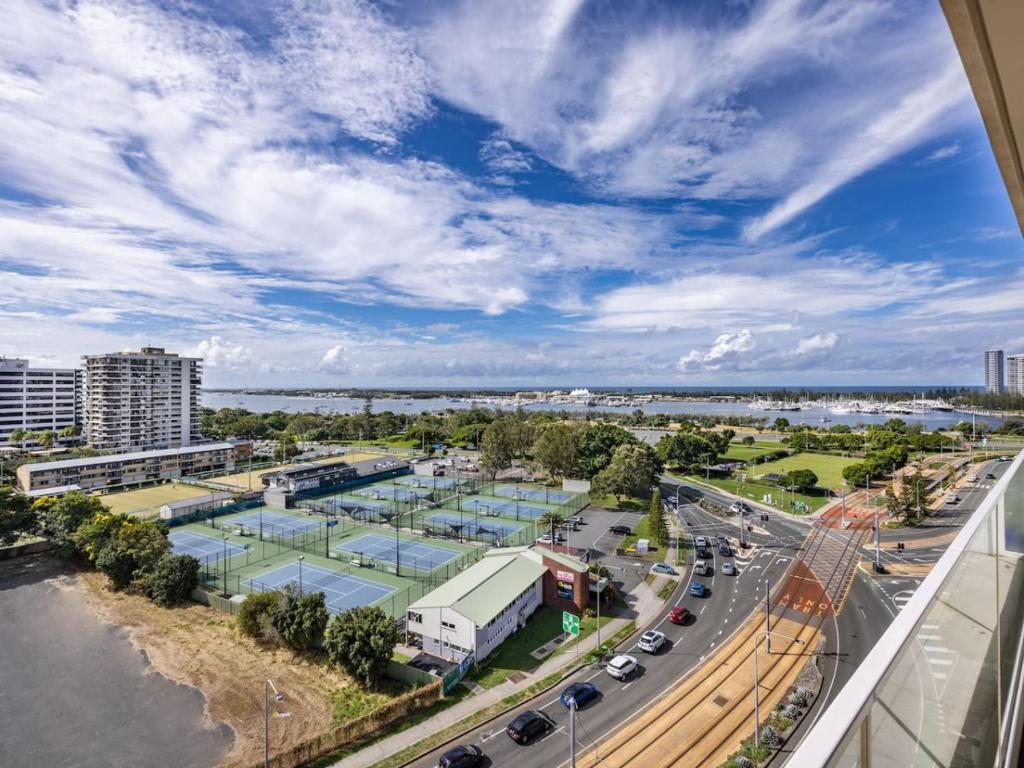 an aerial view of a city with traffic on a highway at Sweeping Ocean view Apt w Carpark and rooftop pool in Gold Coast