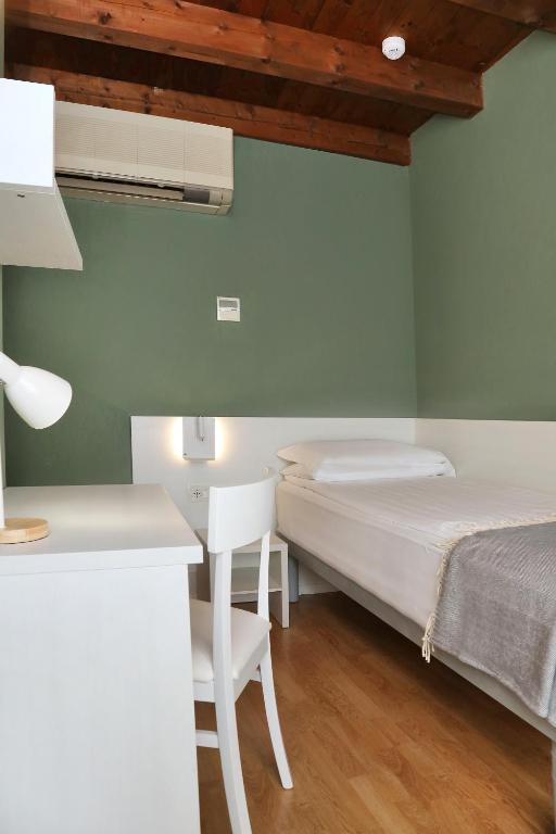 Postel nebo postele na pokoji v ubytování Albergo All'Ancora