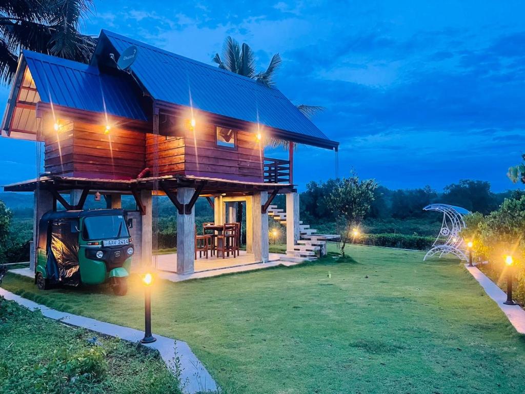 a house with a tractor in front of it at night at Ceylon Nature Paradise in Uragasmanhandiya