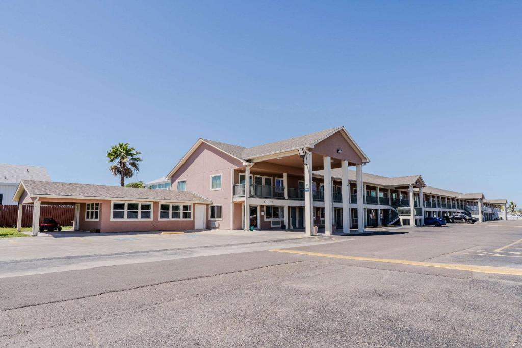 a row of buildings with a parking lot at Quality Inn Rockport on Aransas Bay in Rockport