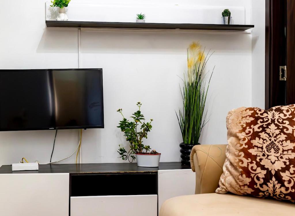 a living room with a tv and a chair at Central Apartment ressidence city in Bucharest