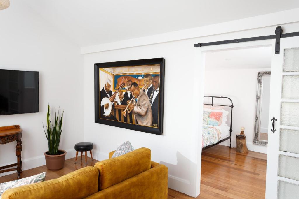 a living room with a couch and a painting on the wall at Studio 39 in Shepparton