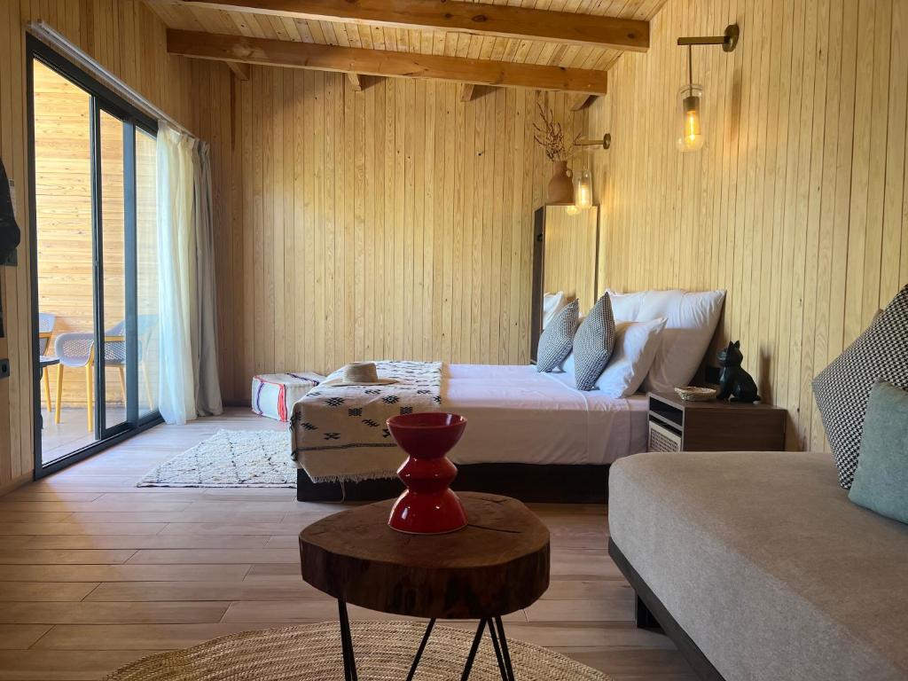 a bedroom with a bed and a couch and a table at Domain The blaze in Marrakech