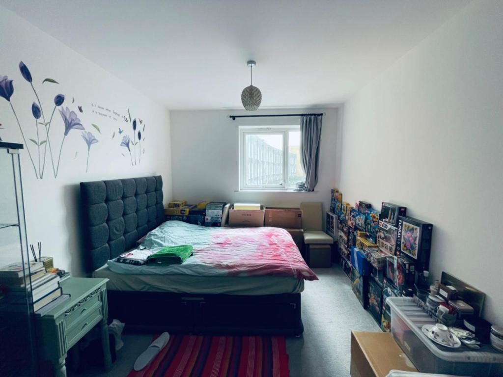 a bedroom with a bed and a window at Your ideal ExCel London- O2 Arena - LCY Airport homestay in Barking