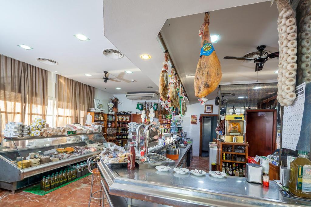 a restaurant with a counter with food on it at Hotel Restaurante Los Molinos in Écija