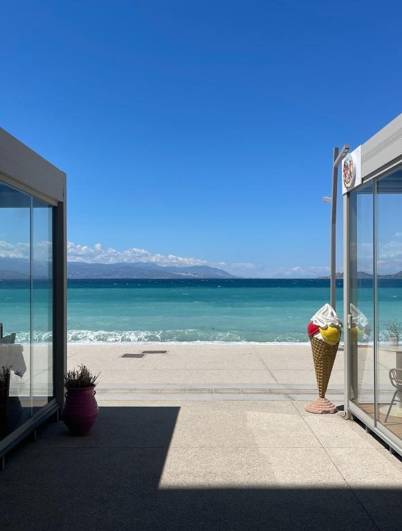 a view of the beach from a bus stop at AGORA luxury APARTMENT 10 in Loutraki