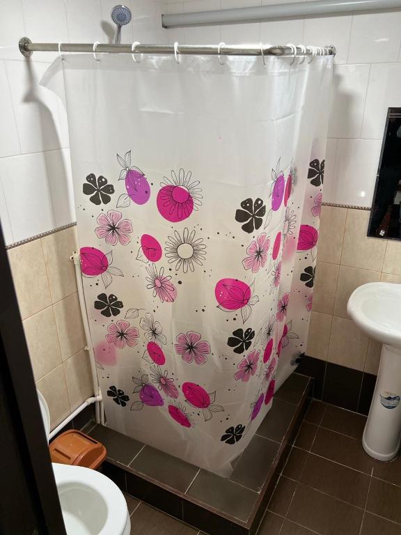a shower curtain with flowers on it in a bathroom at Boutique in Bukhara