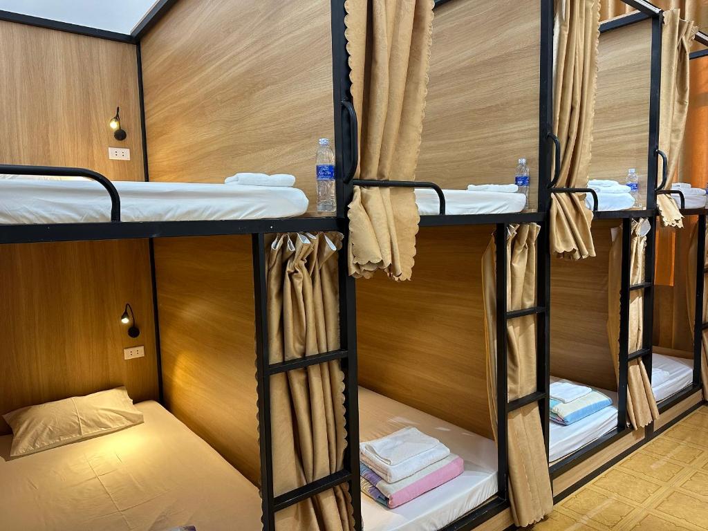 a group of bunk beds in a room at A.MING Backpacker & Tours Điện Biên in Dien Bien Phu