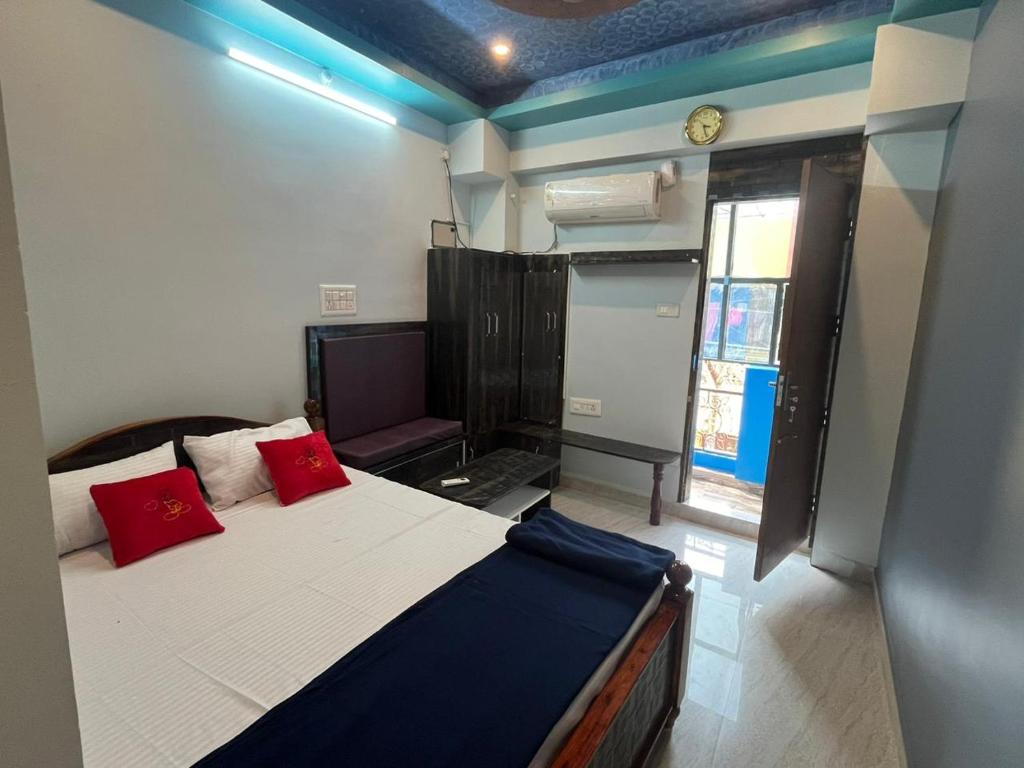 a bedroom with a bed with red pillows on it at PANMOZHI RESIDENCY in Tiruvannāmalai