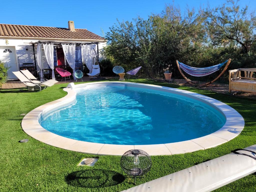 - une piscine dans une cour avec un hamac dans l'établissement Villa piscine, à Marseillan