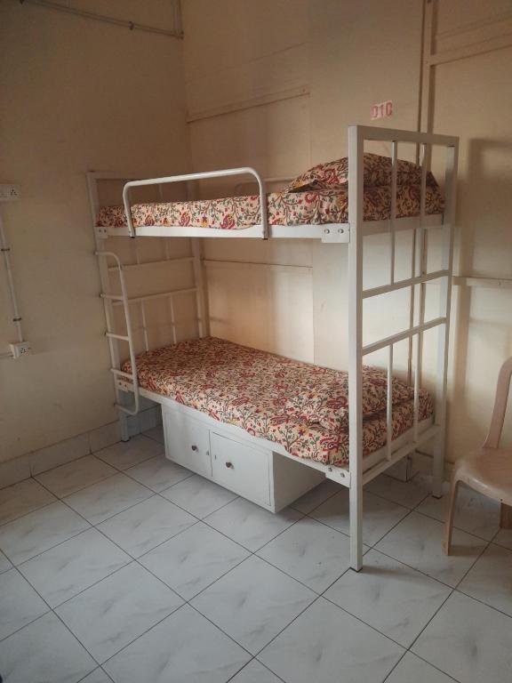 two bunk beds in a small room with a chair at UK YATHRINIVAS in Udupi