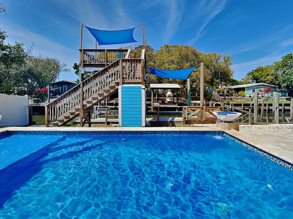 una gran piscina con terraza y escalera en Blue Heron Nest, en St. Augustine