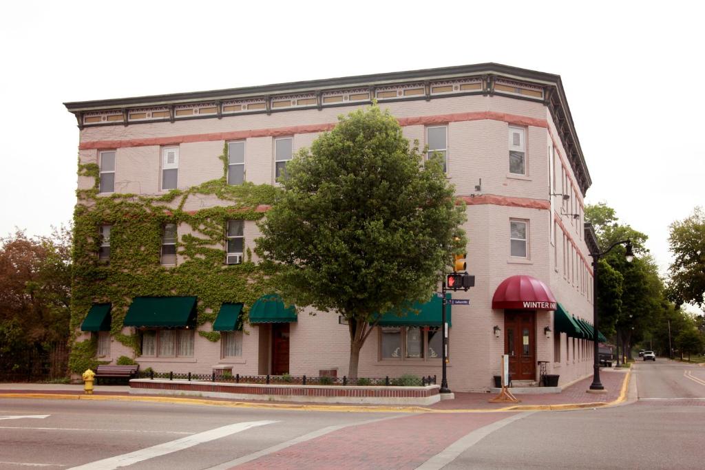a large building with umbrellas on the side of the street at The Winter Inn in Greenville