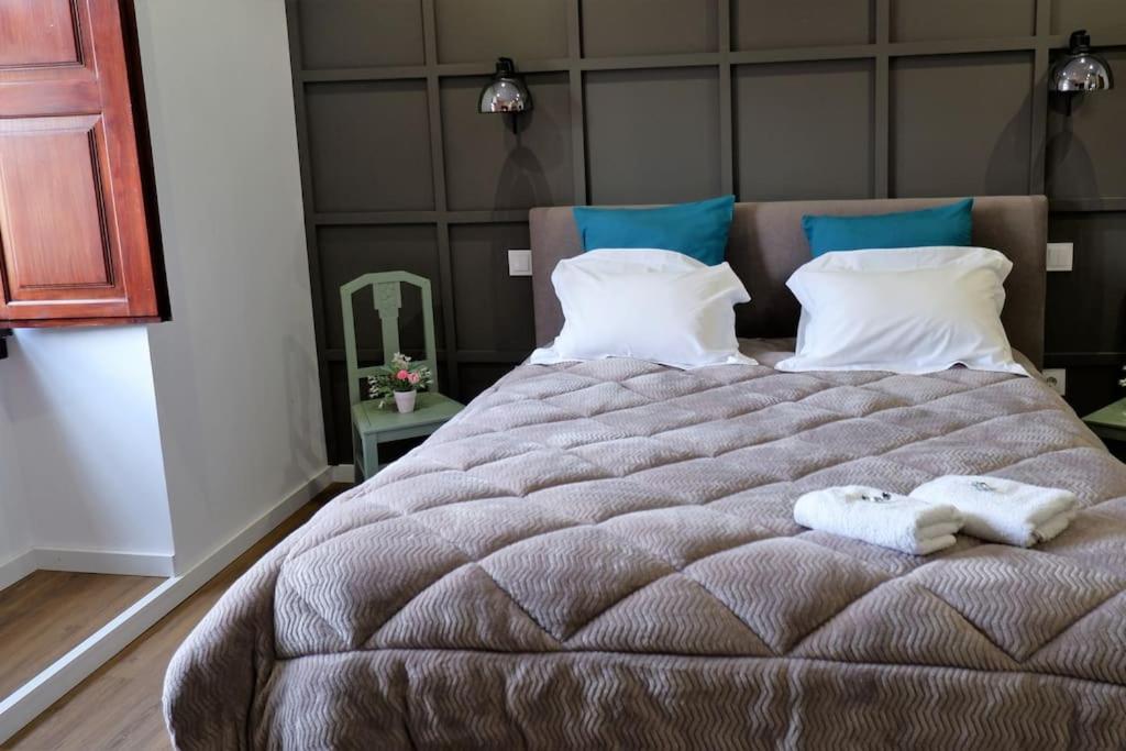 a bedroom with a large bed with two towels on it at O Cantinho do Colégio - Dourocollege in Lamego