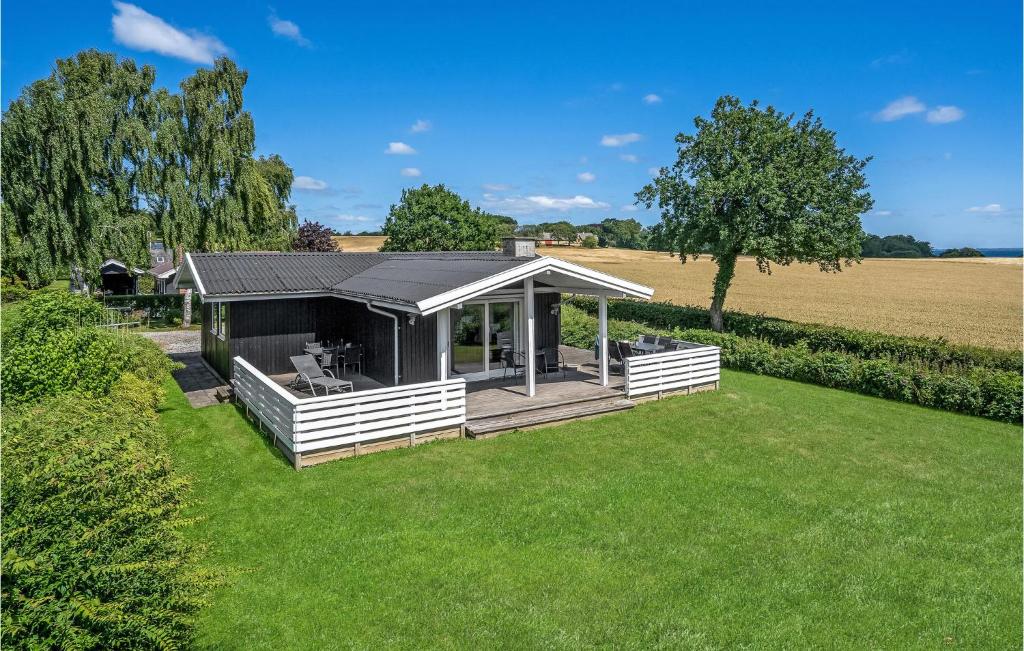 a house with a roof on a grass field at Holiday Home Brombærvænget Hejls I in Hejls