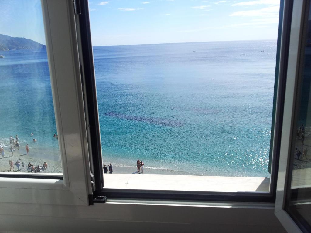 a view of a beach from a window at La Terrazza sul Mare Affittacamere in Monterosso al Mare