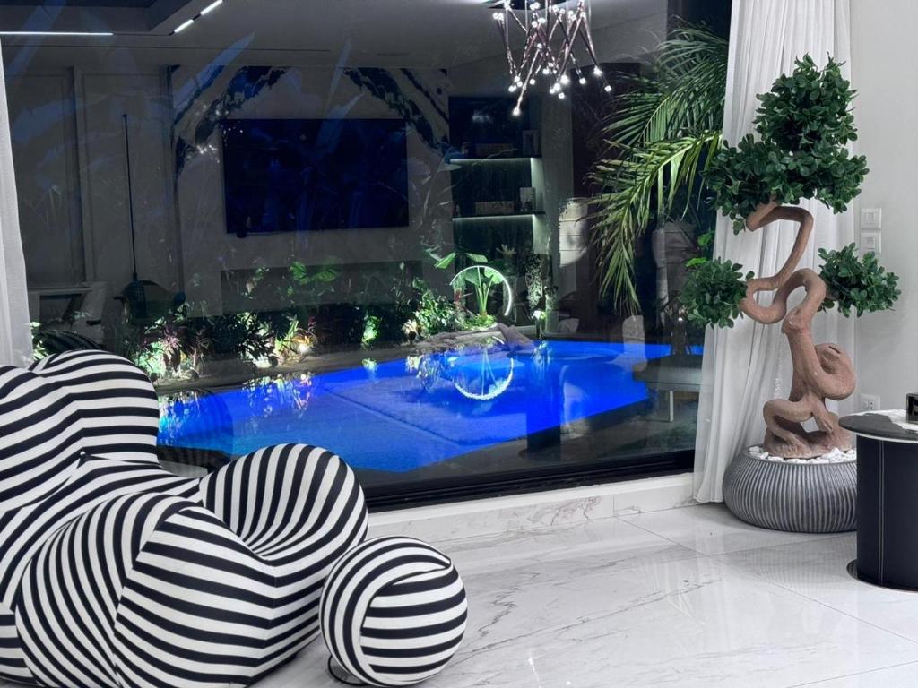 a living room with a swimming pool and a chair at مدينتي in Madinaty