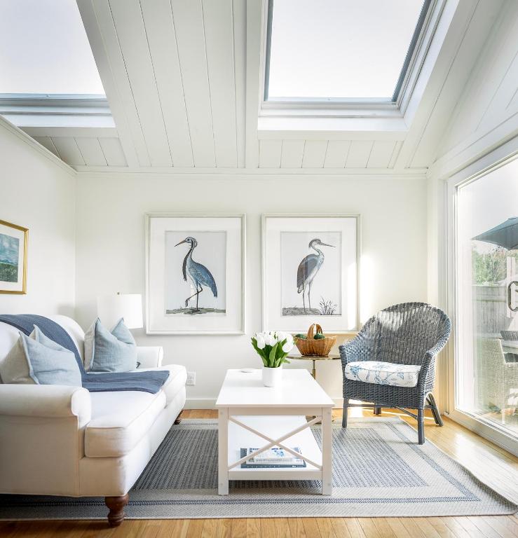 a living room with a white couch and a chair at Stay at Niles Beach in Gloucester