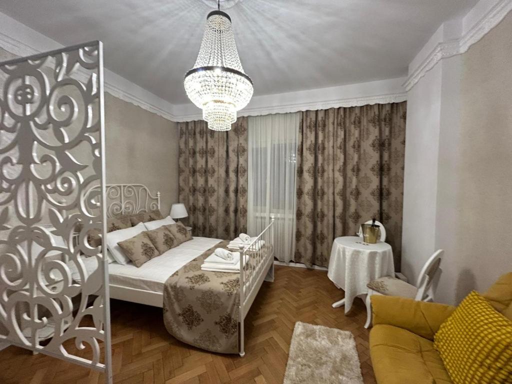 a living room with a bed and a table at UNIVERSITATE-ELEGANT-MIC DEJUN inclus in Bucharest