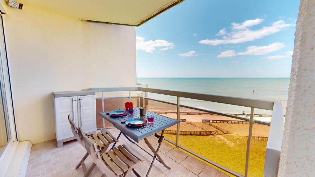 a balcony with a table and chairs and the ocean at Panoramic View face Mer in Saint-Gilles-Croix-de-Vie