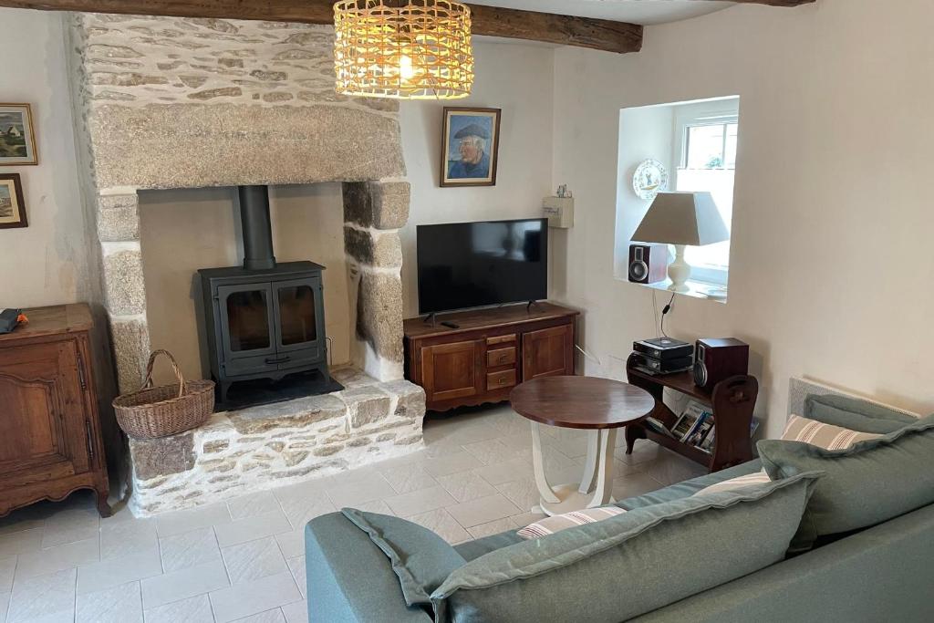 un salon avec un canapé et une cheminée dans l'établissement Maison de pêcheur Roch Priol, à Quiberon