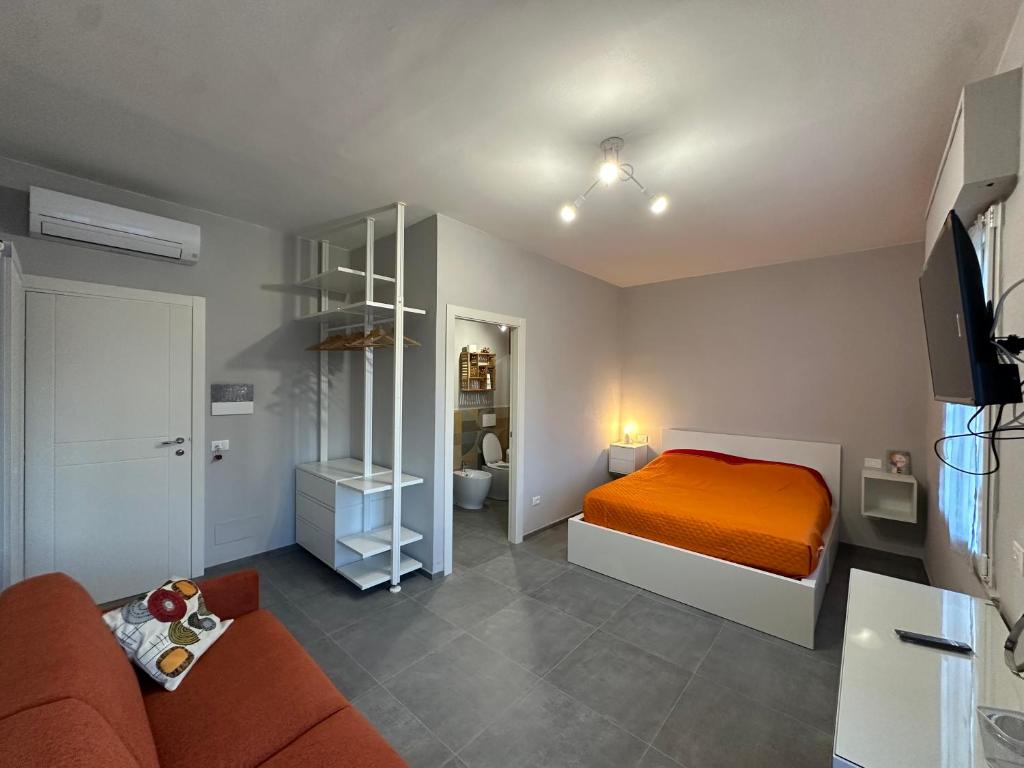 a bedroom with a bed and a living room at Bcube - santa Bona Bed & Breakfast in Pisa