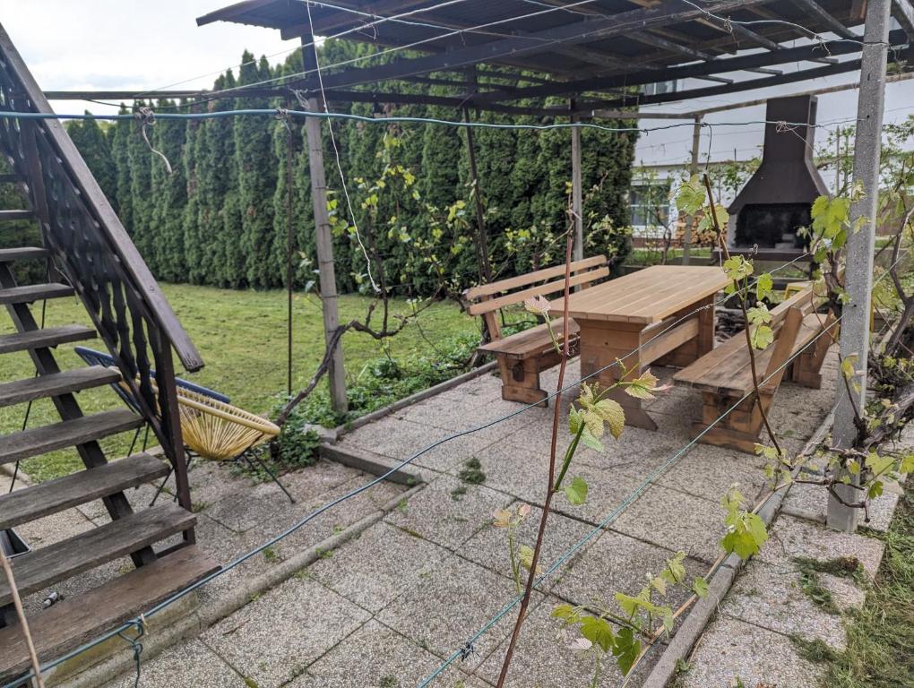 een patio met een schommel, een tafel en een grill bij Dragon's Lair in Celje
