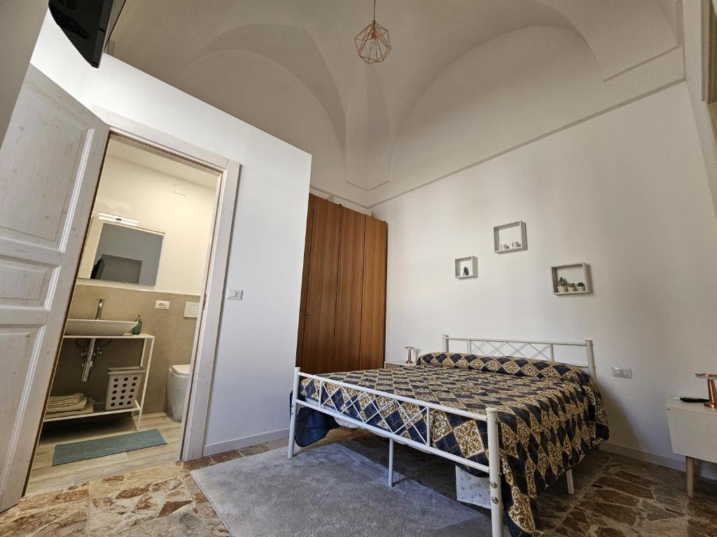 a bedroom with a bed in a room with a mirror at Casa Cesarina in Nardò