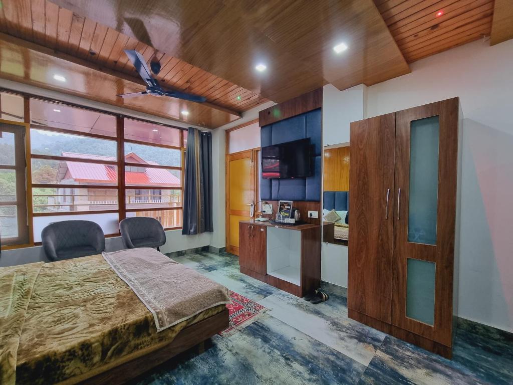 een kamer in een hotel met een bed en een keuken bij Green View By Wow Hotels in Banikhet