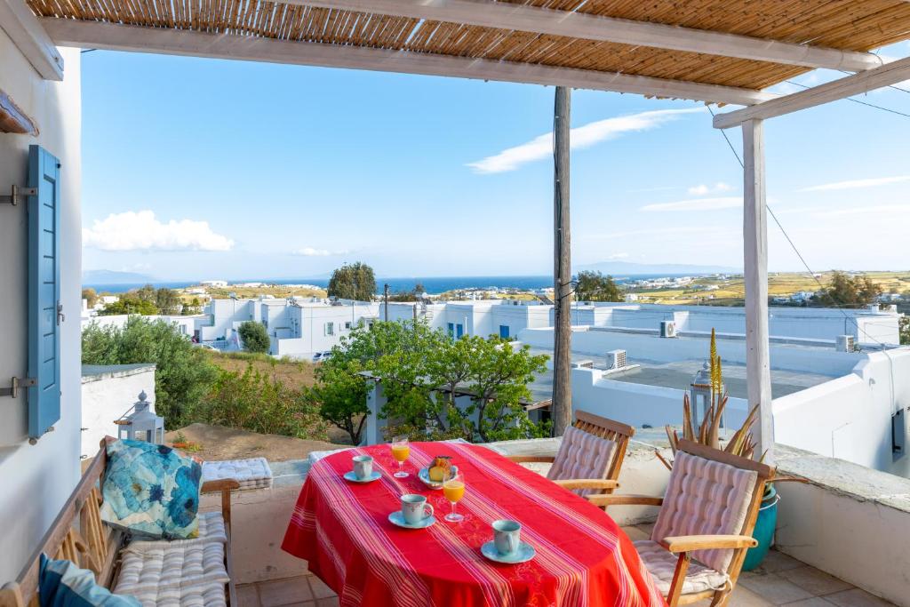 a table and chairs on the balcony of a house at Marpissa Paros house Casa Mira in Kampos Paros