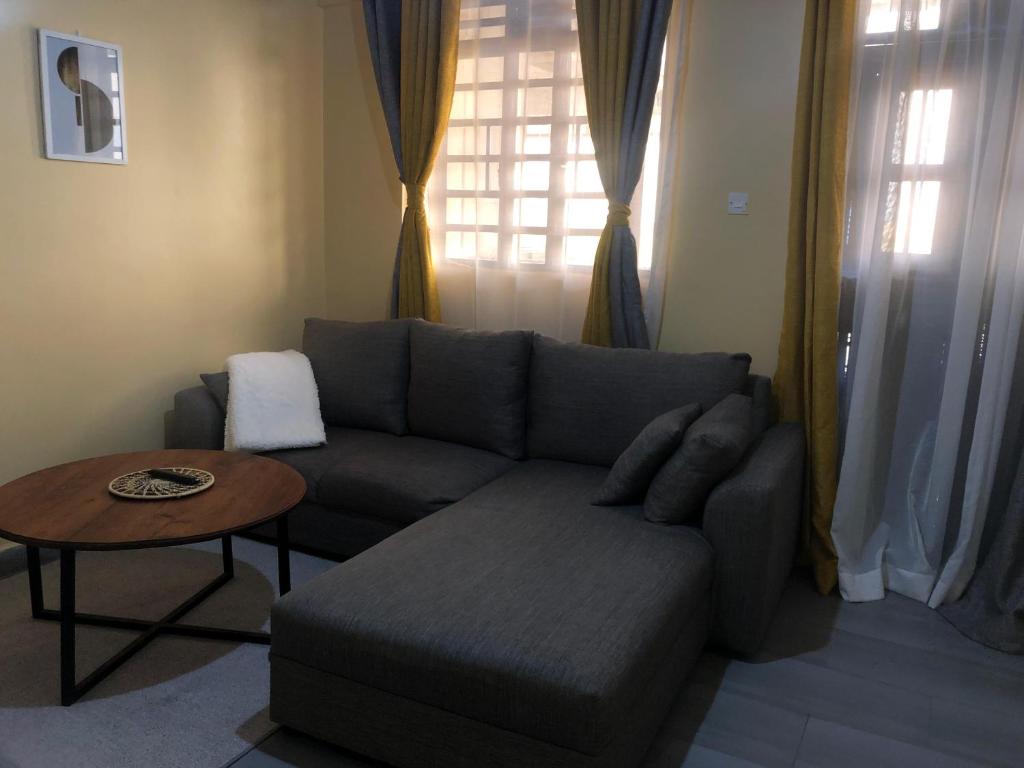 a living room with a couch and a table at Kisumu Airview Homestay in Kisumu
