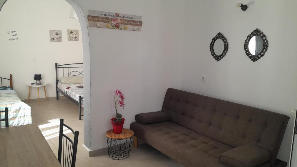 a living room with a couch and a table at SPILIOTICA CENTRAL APARTMENTS in Fira