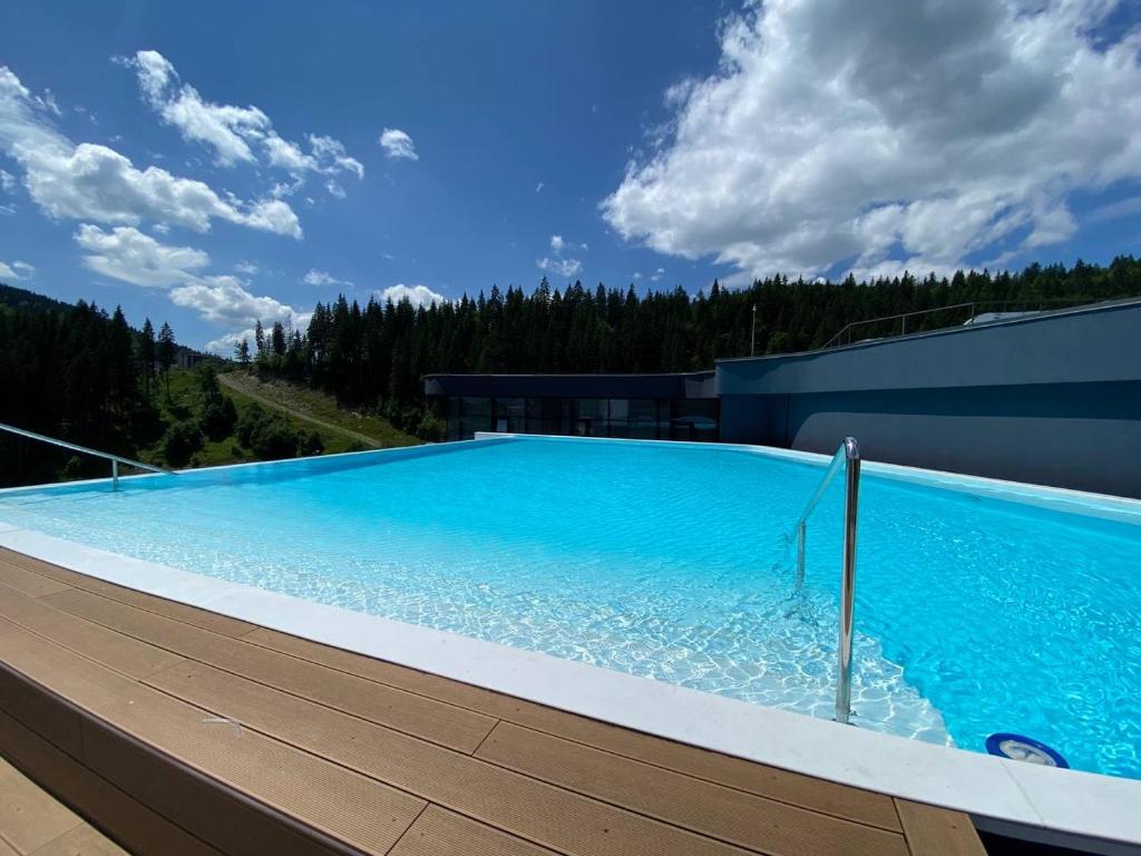 a large swimming pool on top of a building at WOL 07 by Ribas in Bukovel