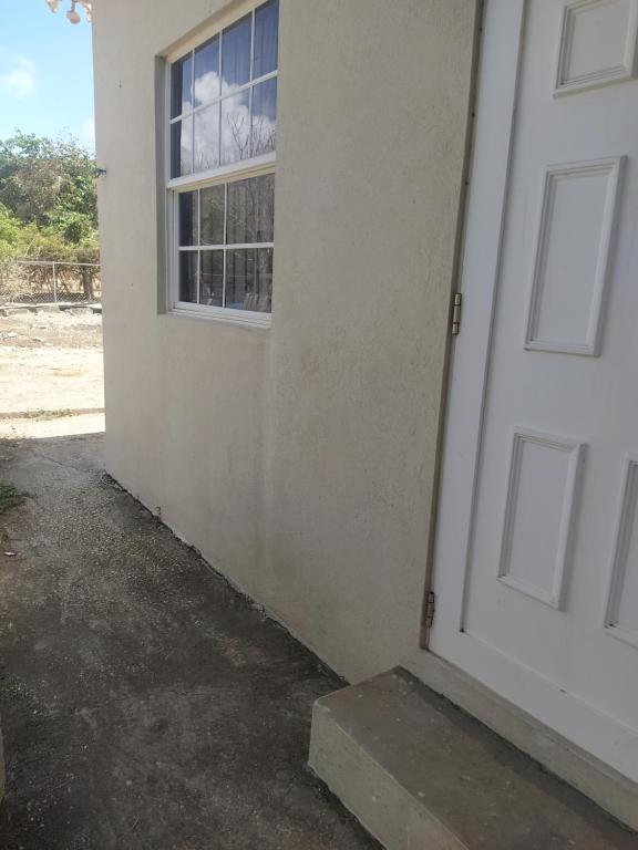 an open door of a house with a window at Cozy Country Home in Saint Philip