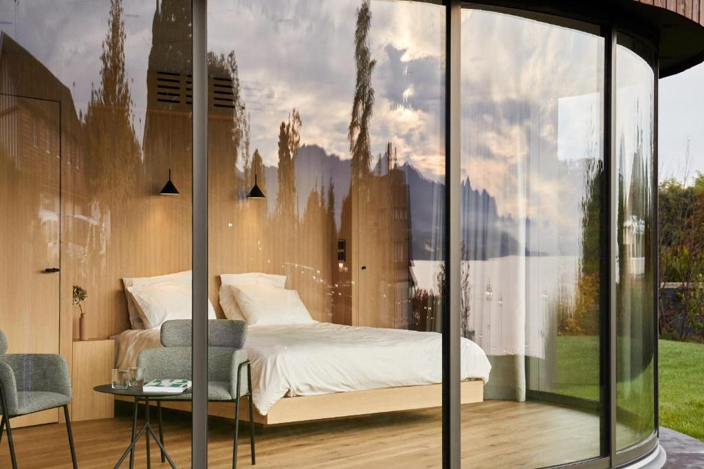 a bedroom with a bed and a glass wall at Sogndal Fjordpanorama- The Panorama View 2 in Sogndal