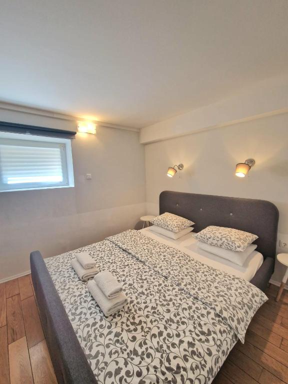 a bedroom with a bed with two towels on it at Max's downtown oasis in Zadar