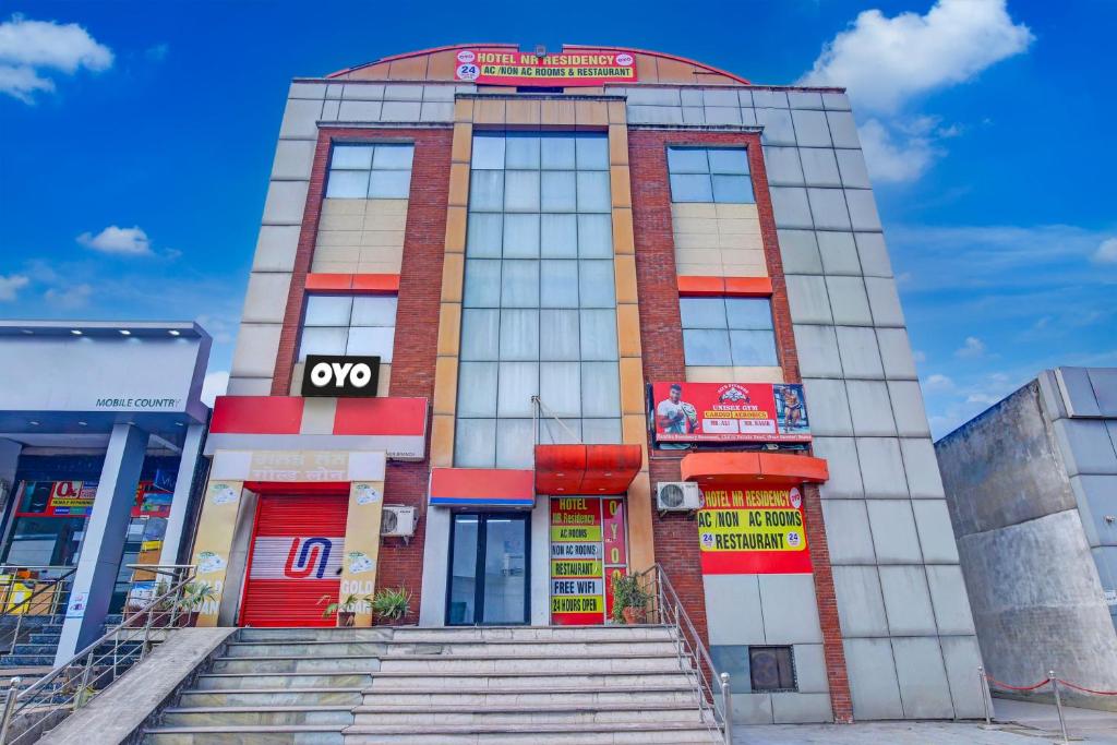 a building with steps in front of it at Super OYO Hotel NR Residency in Banūr
