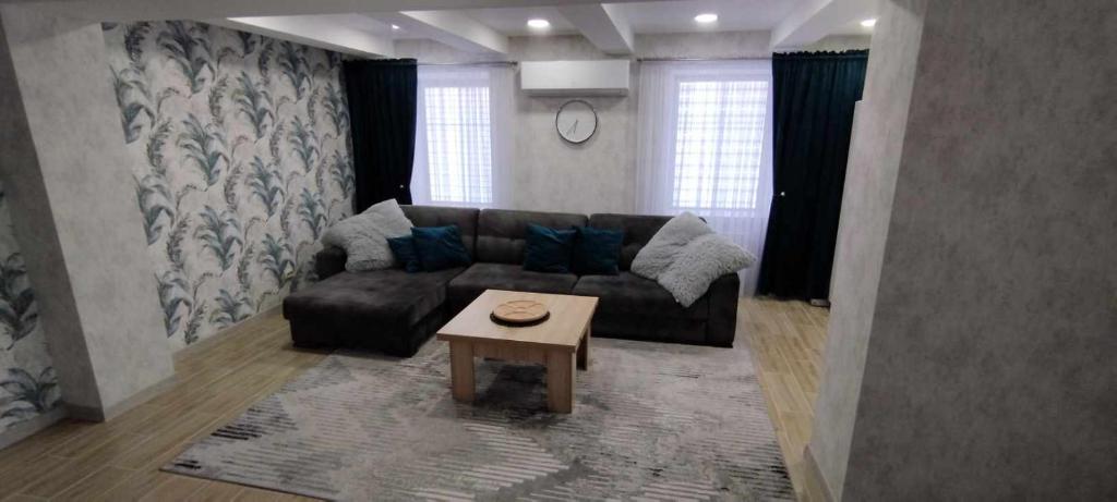 a living room with a couch and a coffee table at Butas Siluteje in Šilutė