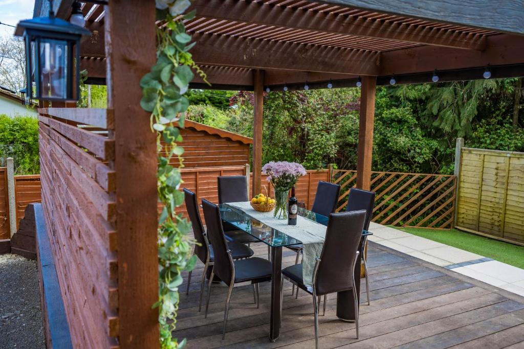 a patio with a table and chairs under a pergola at NEW! A haven by the water in Wootton
