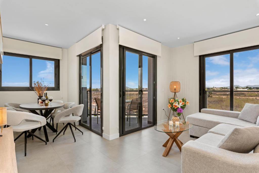 a living room with a couch and a table at Luxe Appartement Lo Pagan - San Pedro del Pinatar 850m from Beach Aldea Del Sol in San Pedro del Pinatar